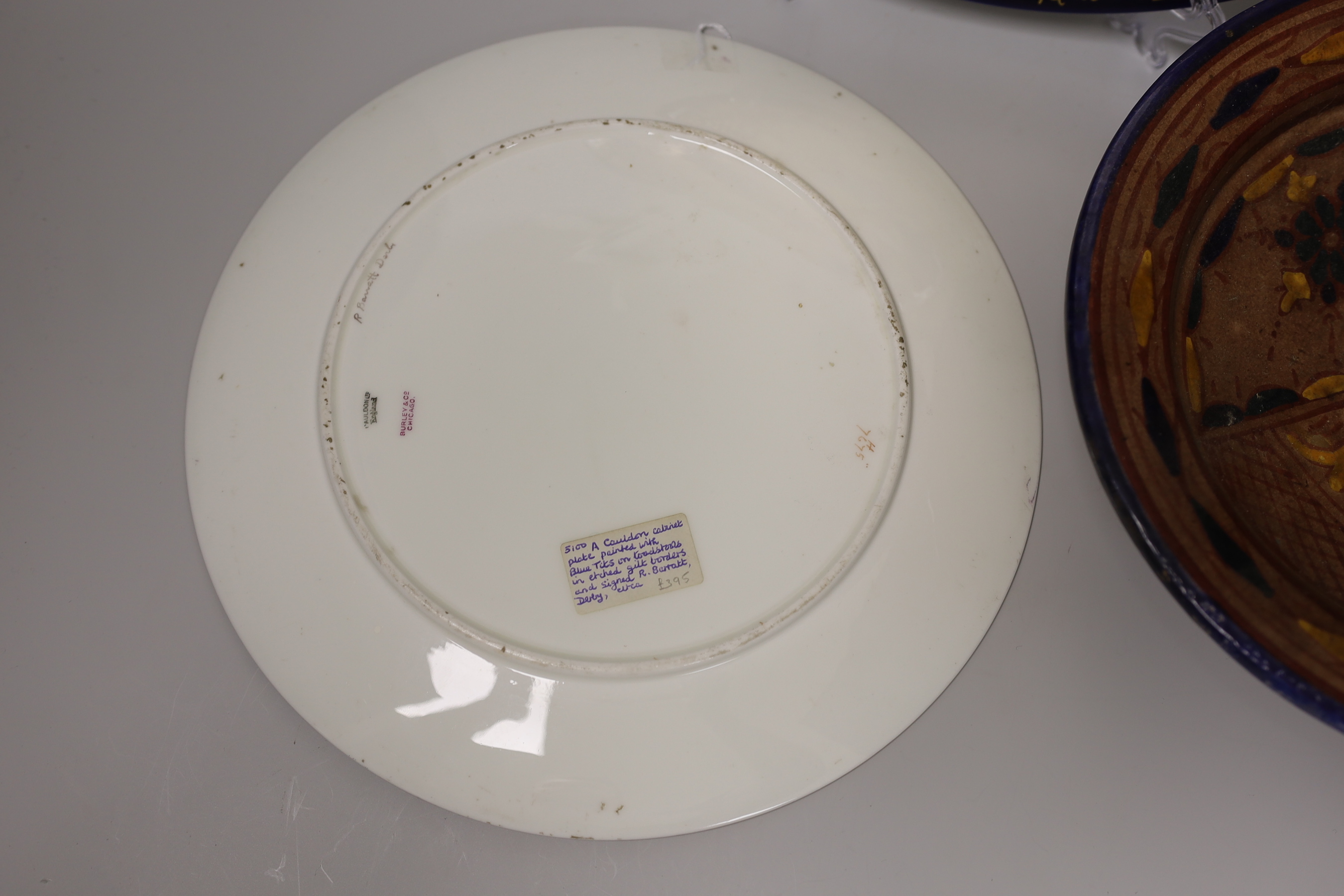 A Cauldon plate painted with blue tits on toadstools and a butterfly on another, signed R. Barratt, Derby, made for Burley & Co. Chicago, a Rosenthal limited edition plate Weihnachtsteller 1980, and an art pottery dish